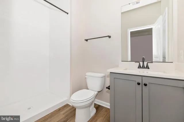 a bathroom with a toilet a sink and mirror