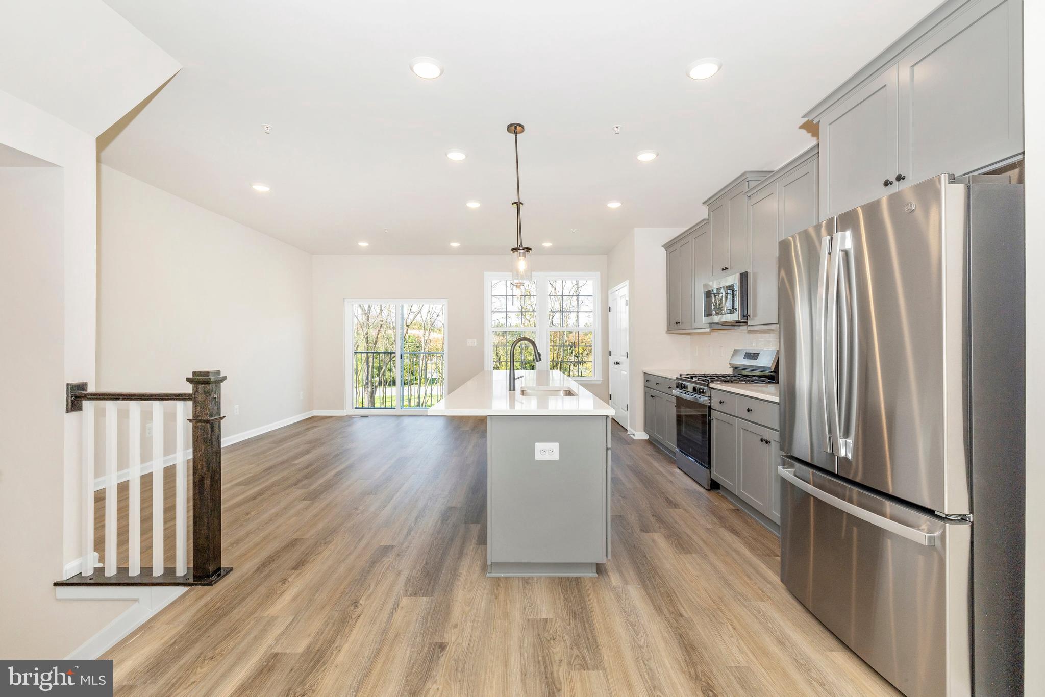 107 Spring Bank Way Frederick, MD 21701 - Photo 5 of 13 a large kitchen with granite countertop a large window appliances and cabinets