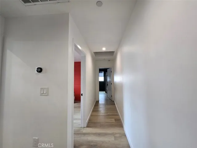a view of a hallway with wooden floor