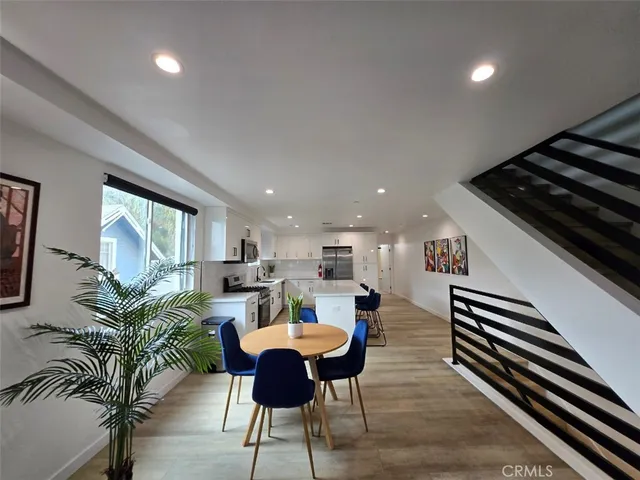 a dining room with furniture and wooden floor