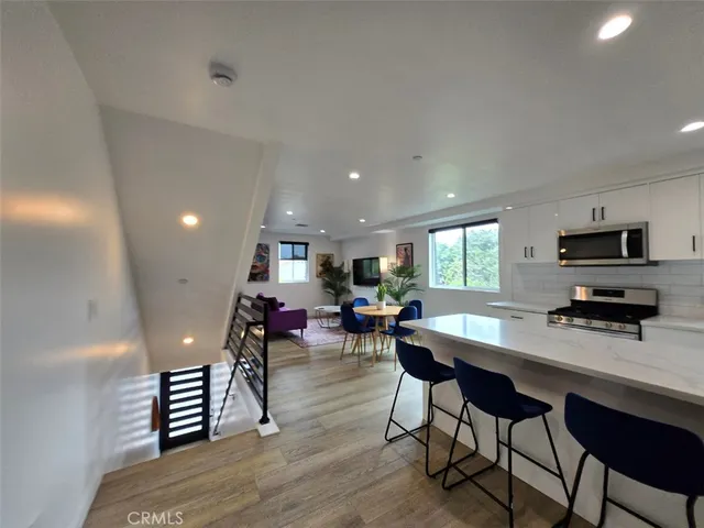 a view of a dining room with furniture window and wooden floor