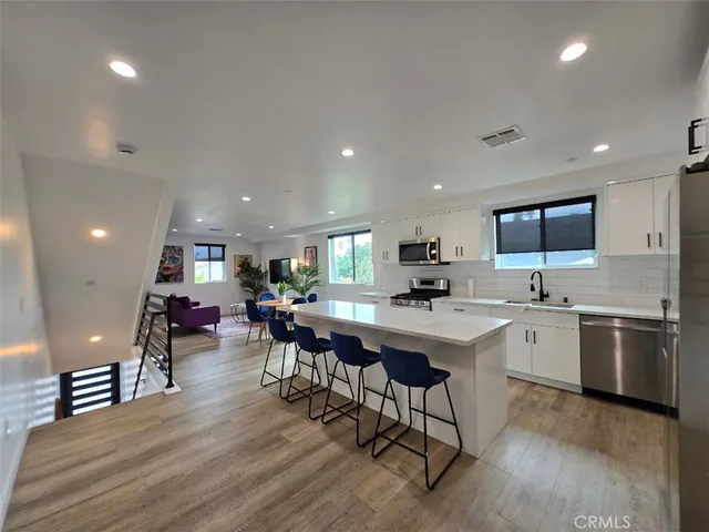a kitchen with lots of counter top space and furniture