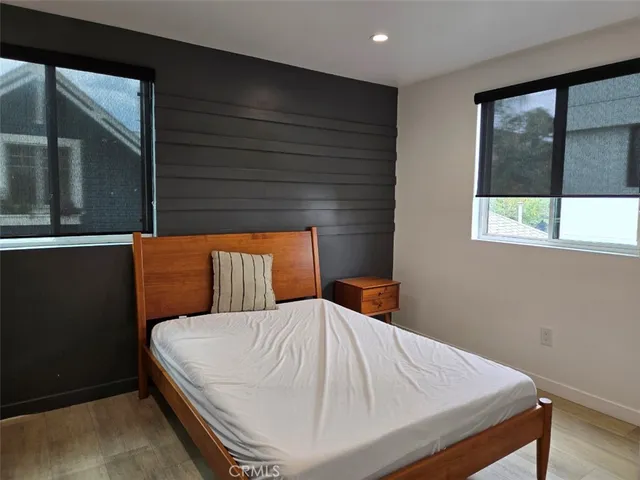 a bed sitting in a bedroom next to a window