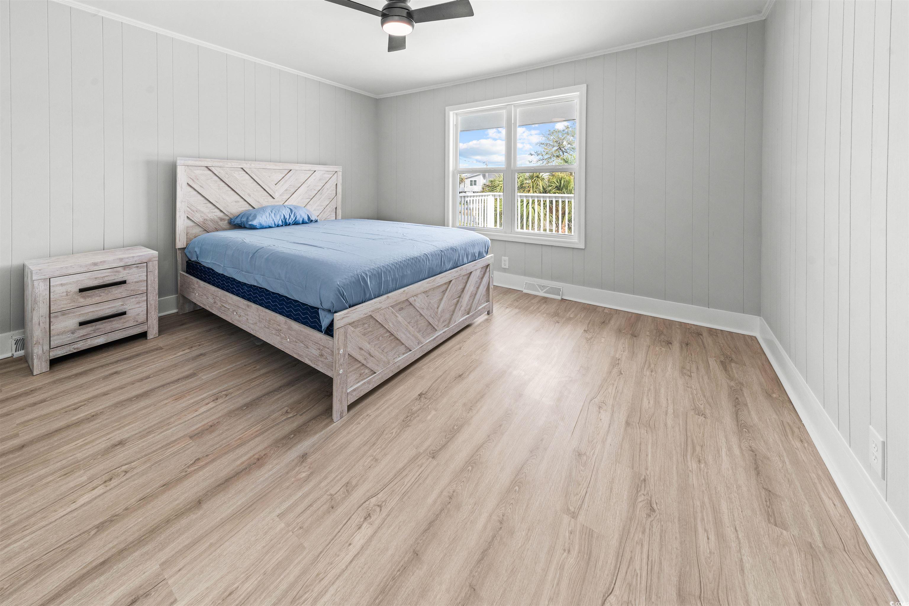 338 State Rd S-26-530 Murrells Inlet, SC 29576 - Photo 26 of 39 Bedroom with visible vents, crown molding, light wood finished floors, baseboards, and a ceiling fan