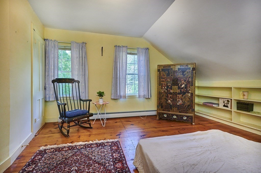 416 Bay Road Amherst, MA 01002 - Photo 14 of 42 a bedroom with a bed a table and chair