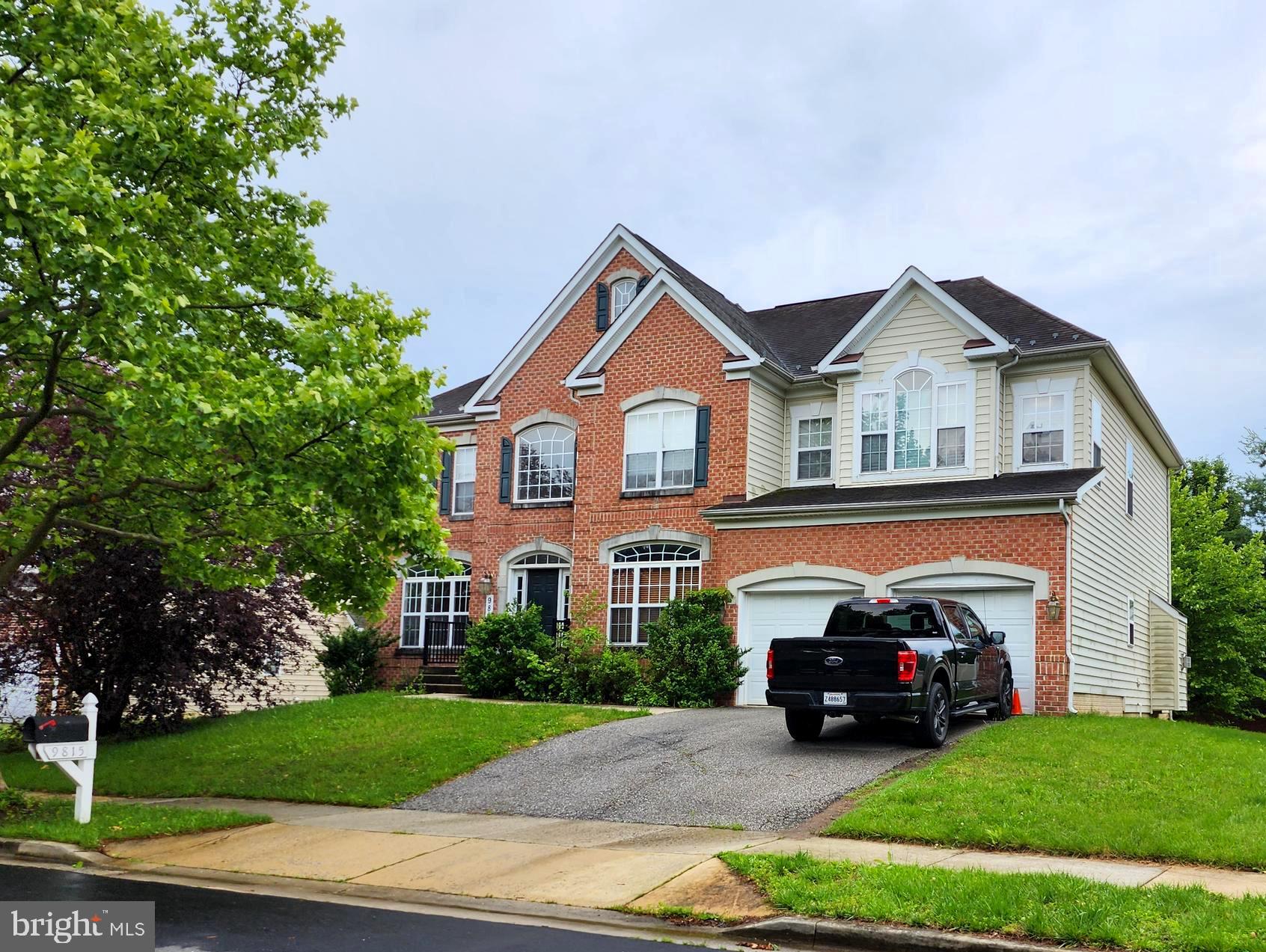 a view of a house with a garden and parking space