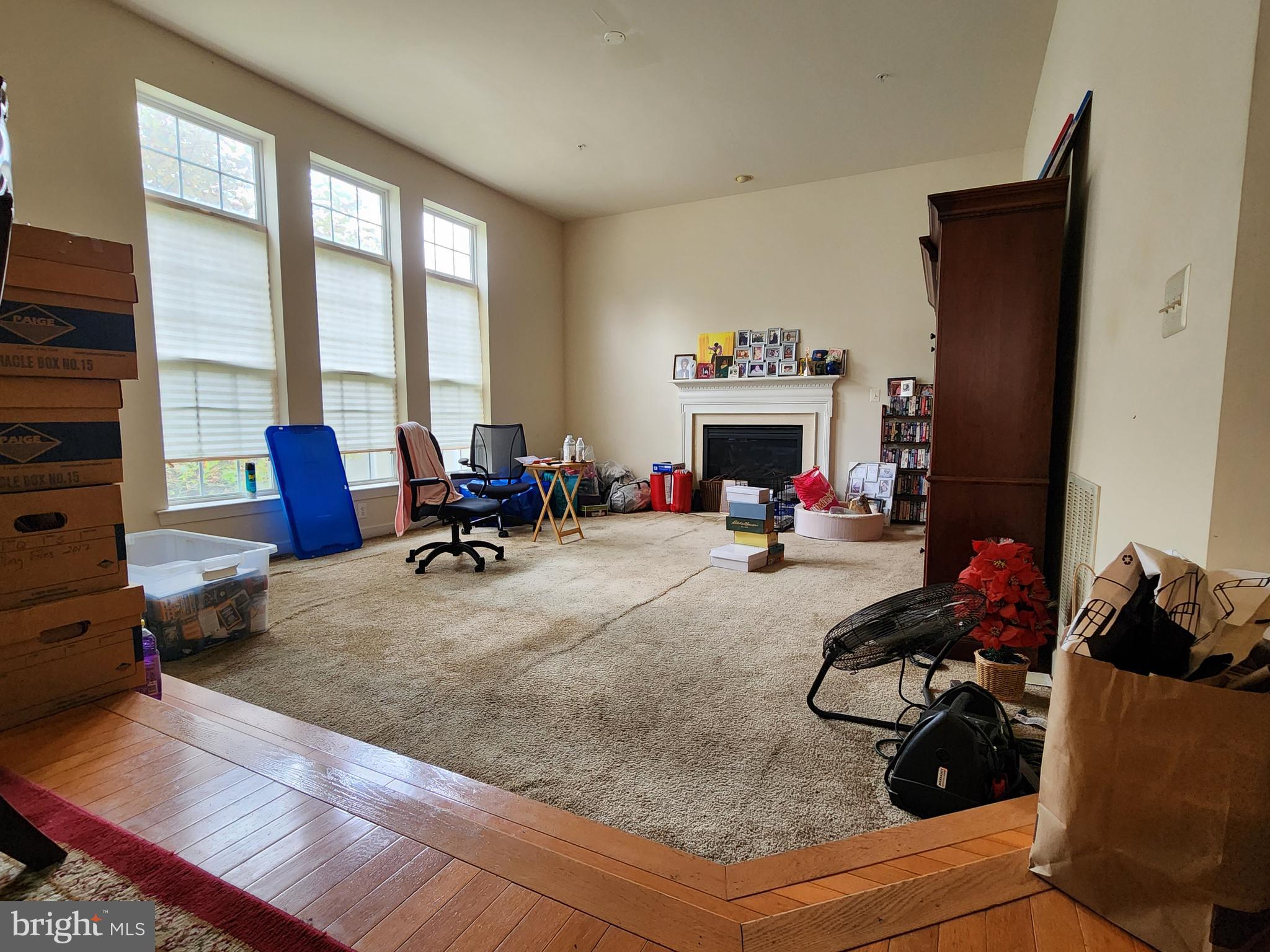 9815 Oxbridge Way Bowie, MD 20721 - Photo 17 of 28 a living room with furniture fireplace and a large window