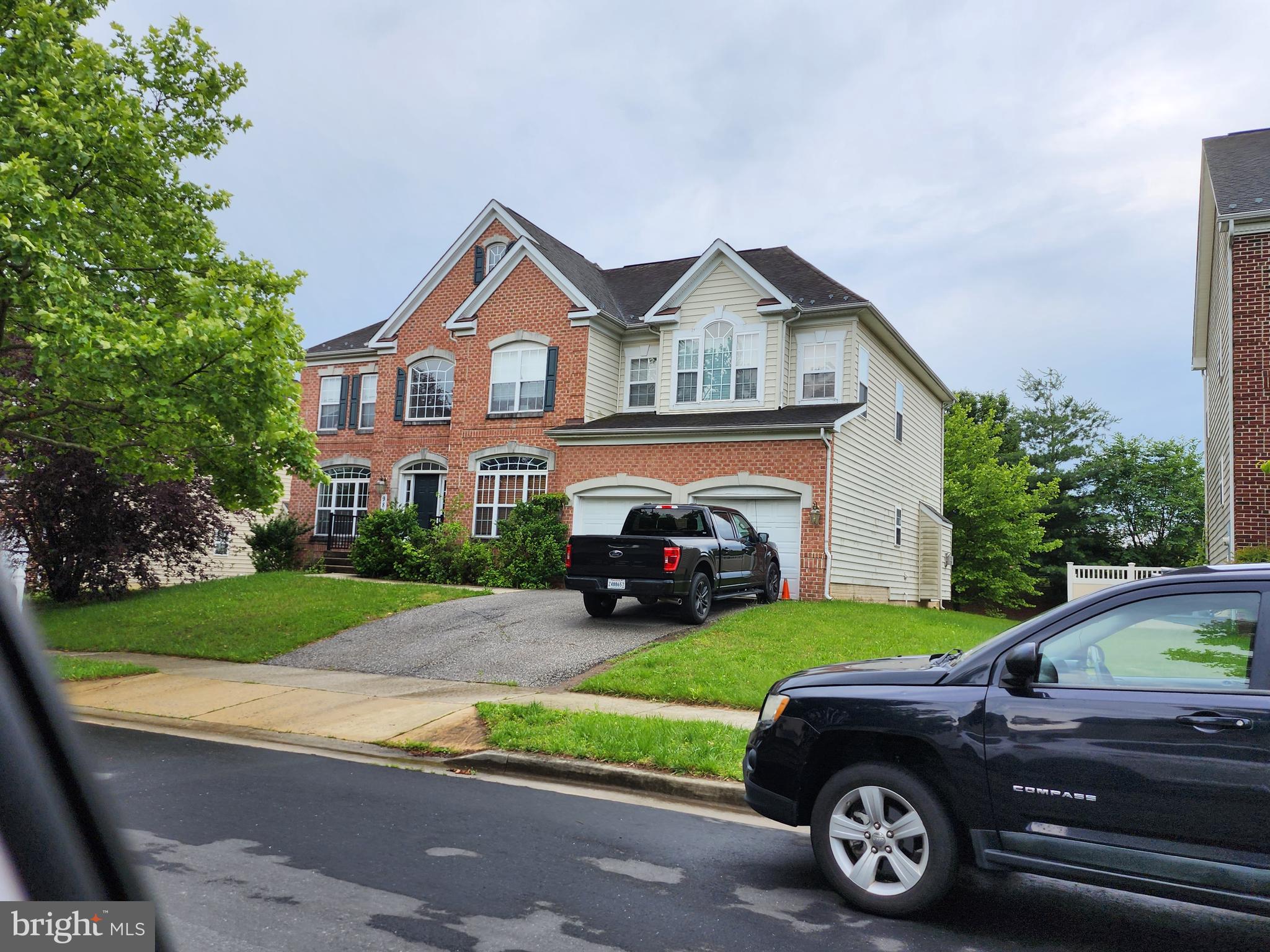 9815 Oxbridge Way Bowie, MD 20721 - Photo 22 of 28 a car parked in front of a house with a yard
