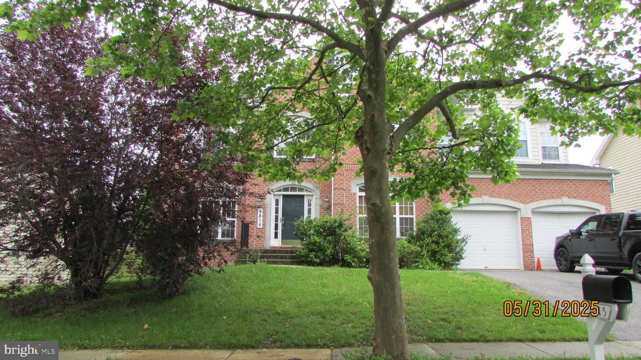 9815 Oxbridge Way Bowie, MD 20721 - Photo 23 of 28 a front view of a house with a yard and trees