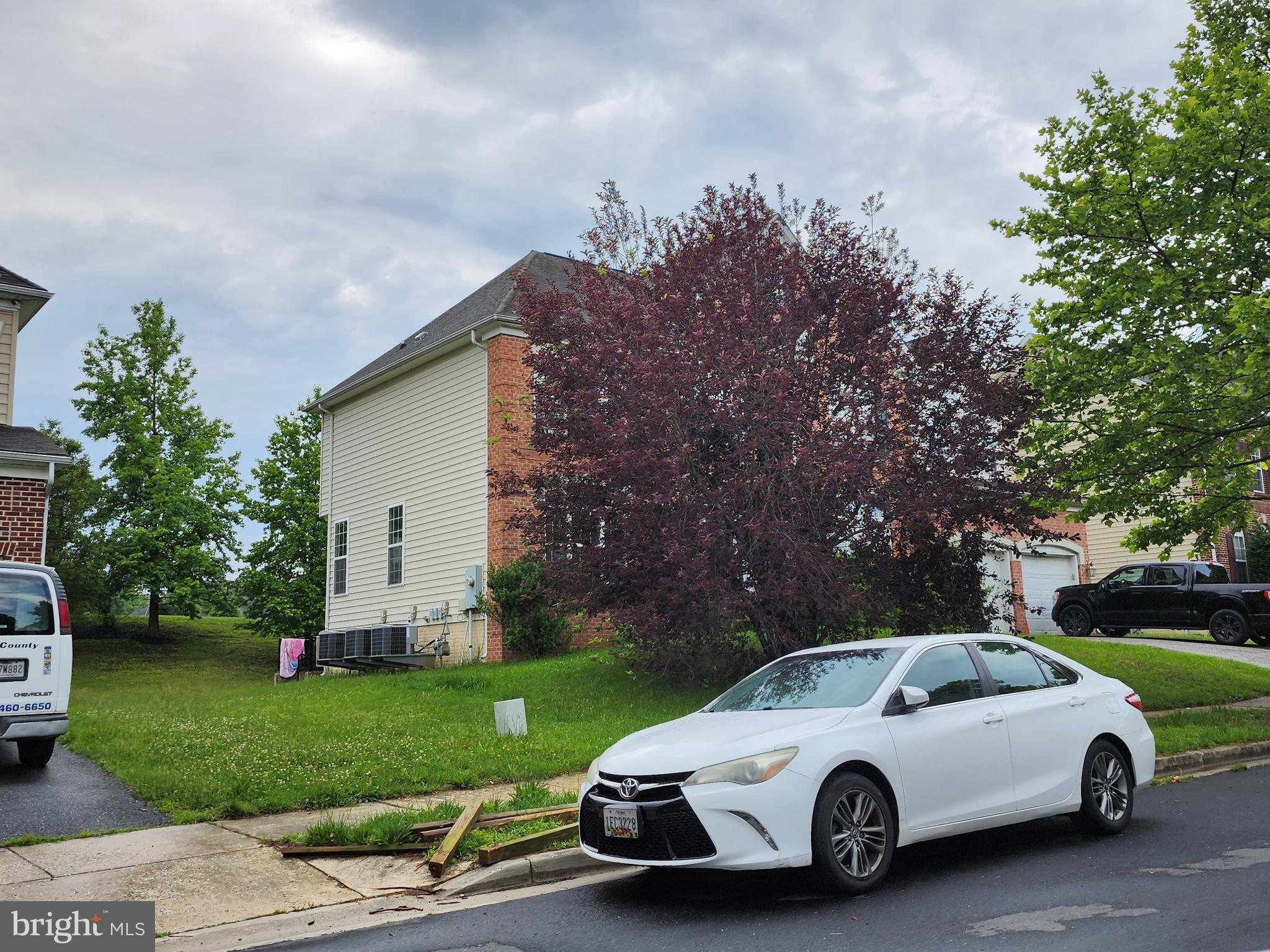 9815 Oxbridge Way Bowie, MD 20721 - Photo 24 of 28 a view of a car in front of a house with a yard