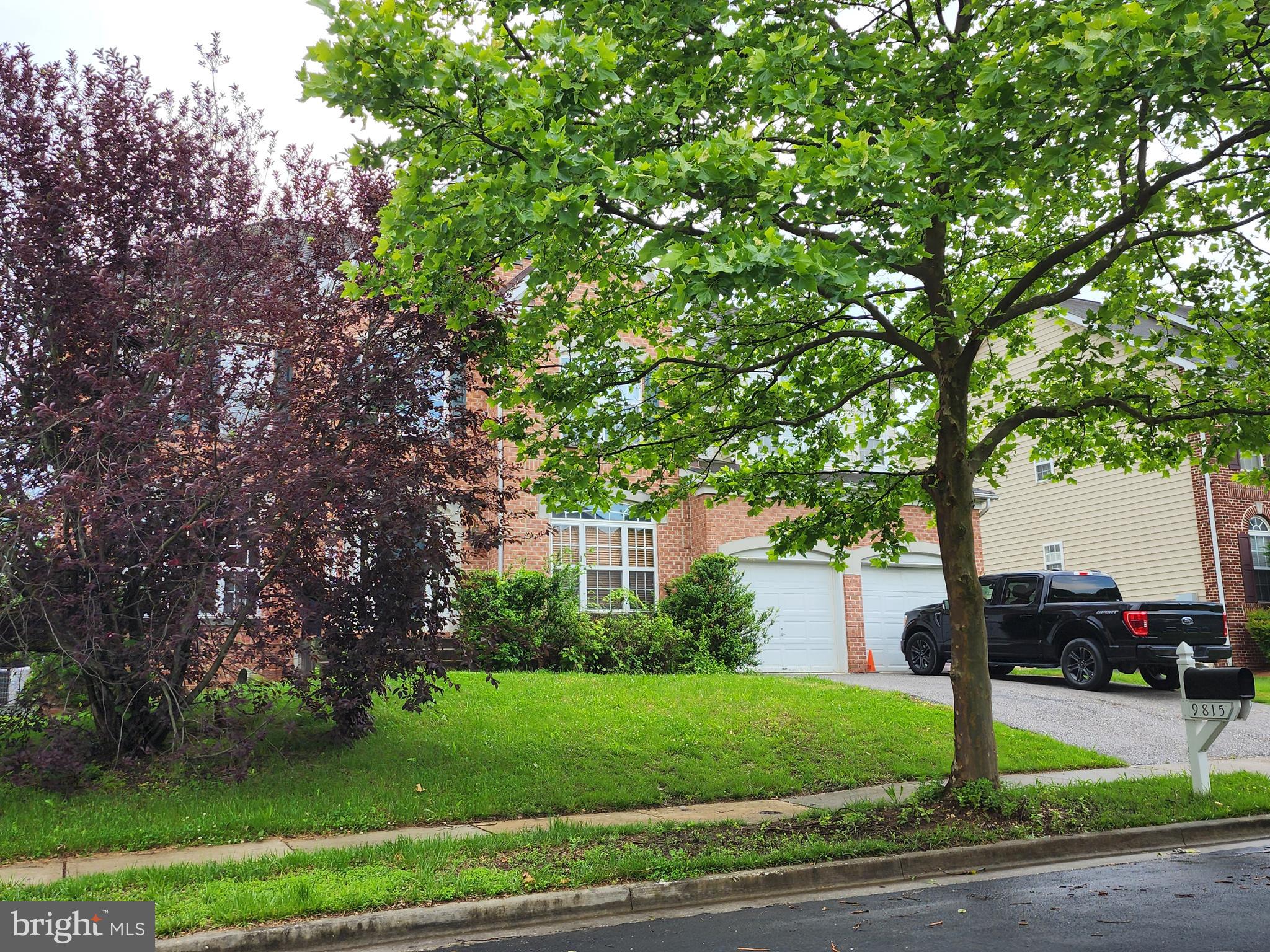 9815 Oxbridge Way Bowie, MD 20721 - Photo 26 of 28 a front view of a house with a yard and trees