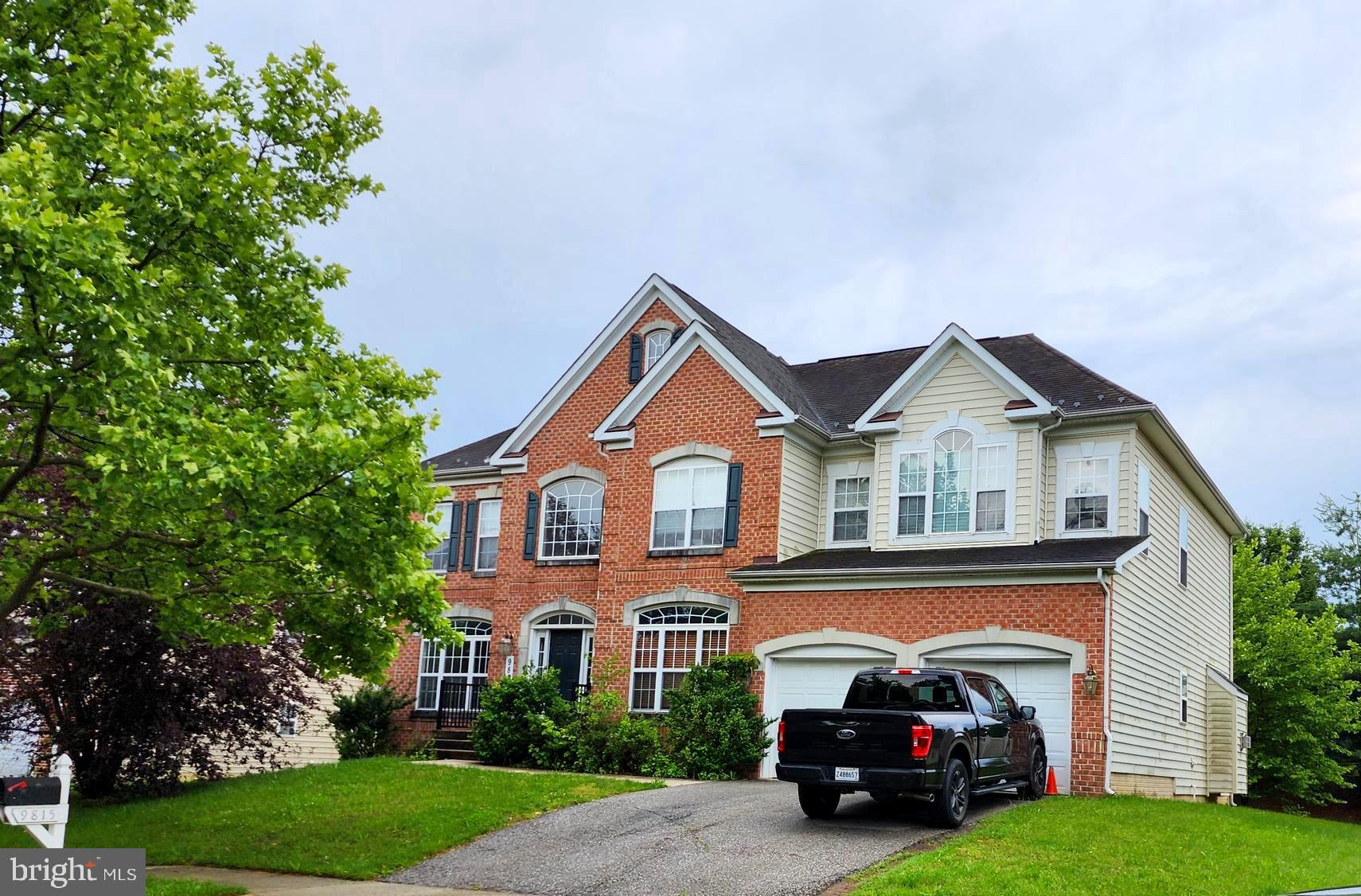 9815 Oxbridge Way Bowie, MD 20721 - Photo 8 of 28 a car parked in front of a house with a small yard