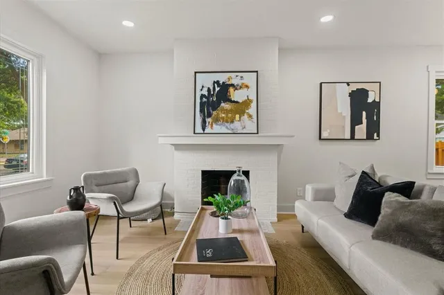a living room with furniture fireplace and window