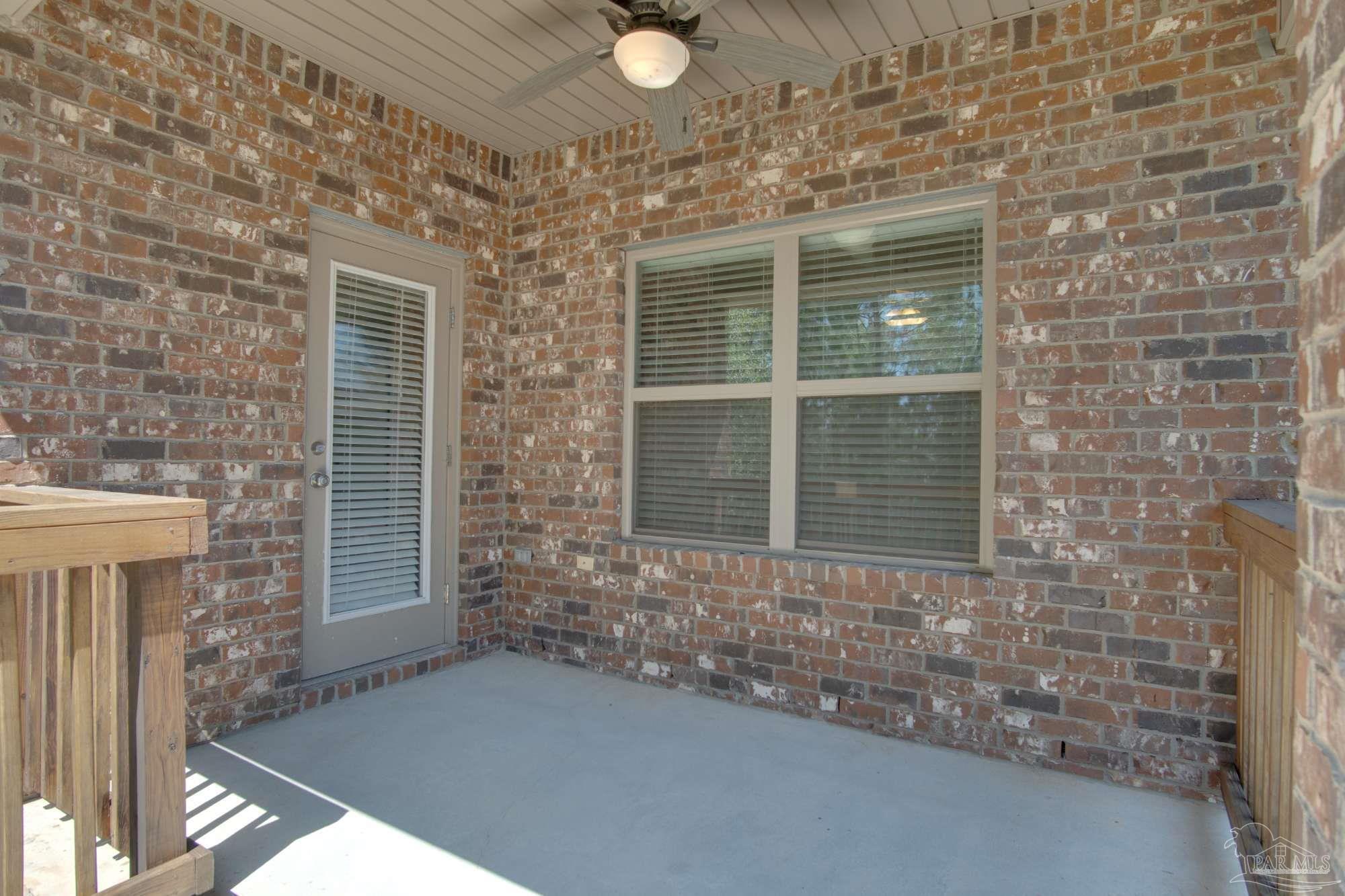 6239 Ladera Trail Pace, FL 32571 - Photo 26 of 27 a view of a brick house with a window