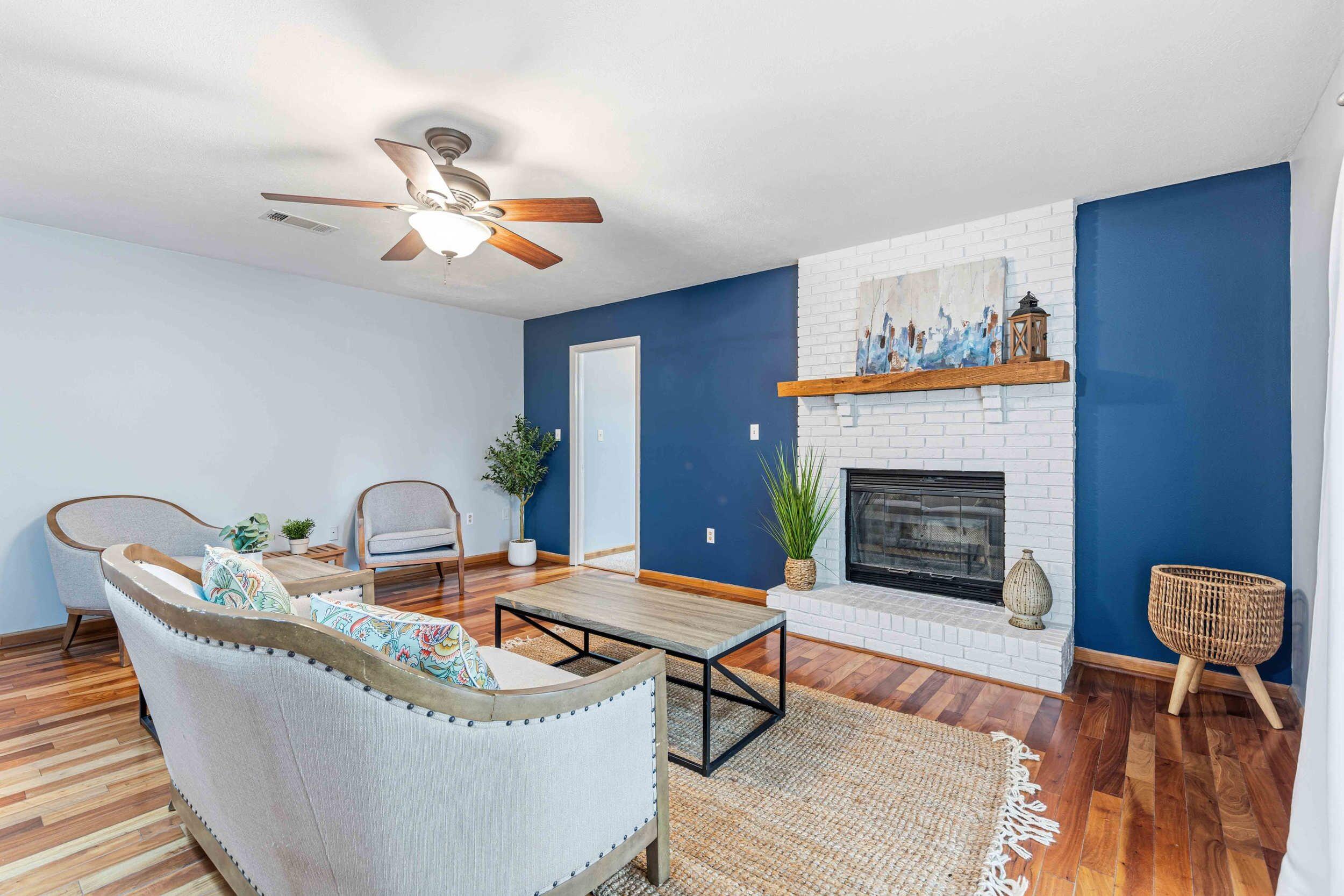 a living room with furniture and a fireplace