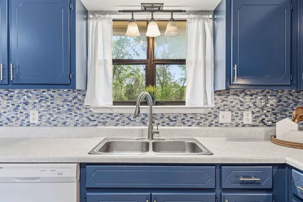 a bathroom with a sink and a window