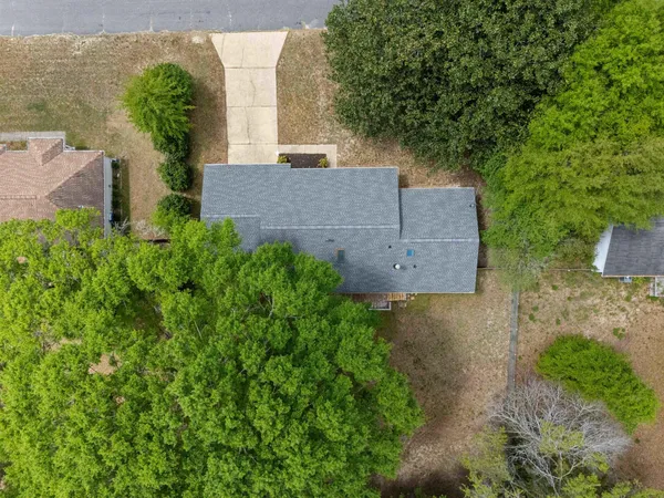 an aerial view of a house with garden space and street view