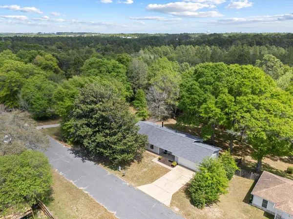 an aerial view of a house with a yard