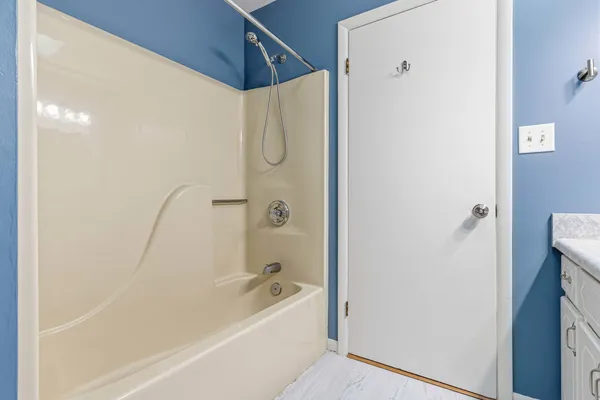 a bathroom with a bathtub and a shower
