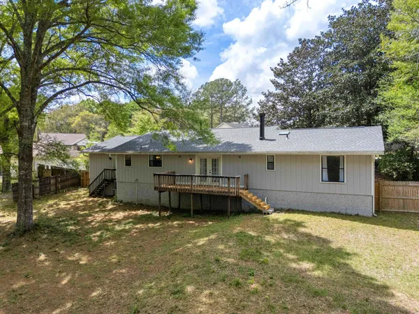a view of a house with a yard and sitting area