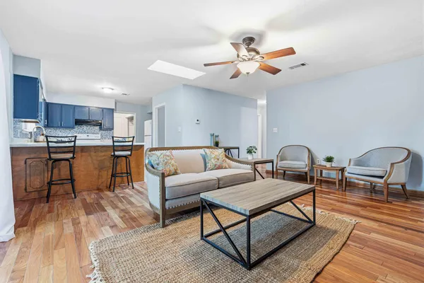 a living room with furniture and kitchen view