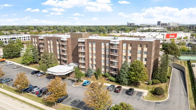 a view of a balcony with chairs and a potted plant