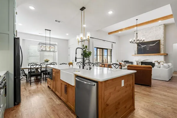 a large kitchen with kitchen island a sink a counter space and stainless steel appliances