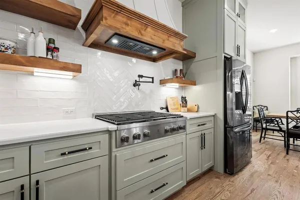 a kitchen with stainless steel appliances granite countertop a stove and a sink