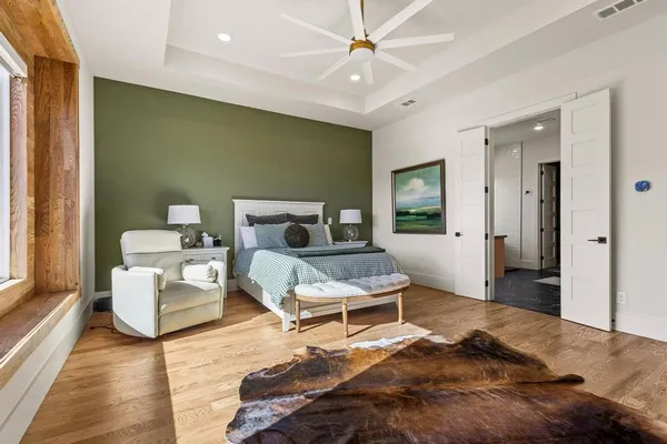 a bedroom with furniture and wooden floor