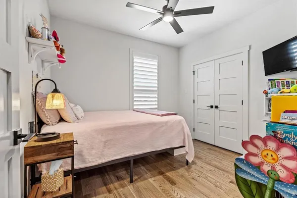 a bedroom with a bed and wooden floor