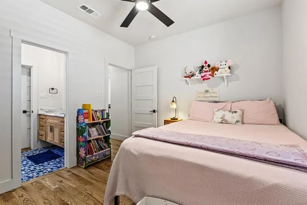 a bedroom with a bed and a book shelf