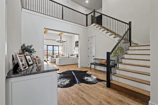 a living room with wooden floor and a table