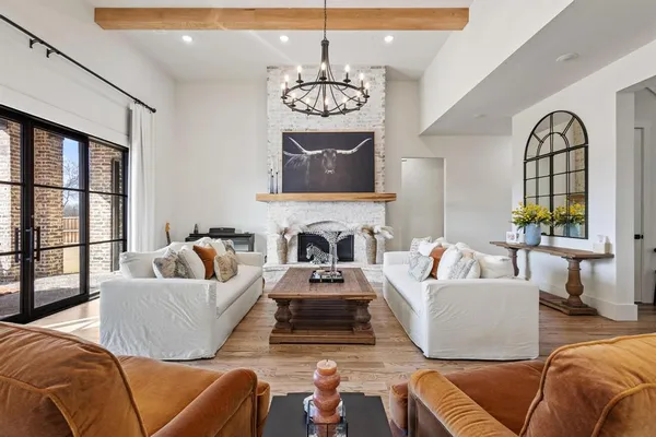 a living room with furniture fireplace and window