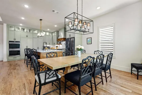 a view of a dining room with furniture wooden floor and chandelier