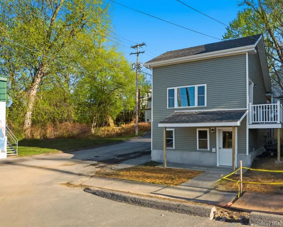 a house that has a tree in front of it