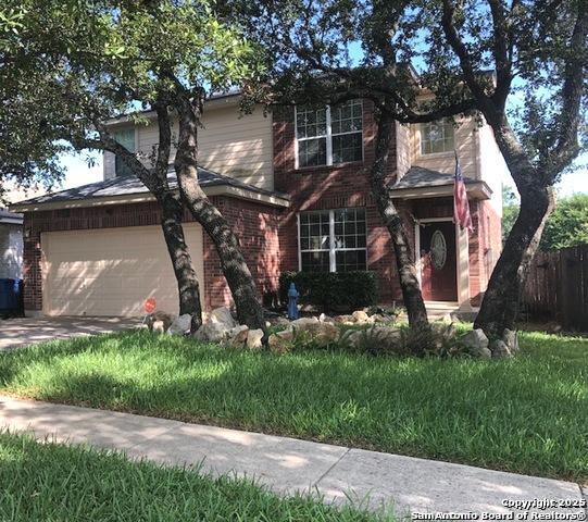 a front view of house with a garden