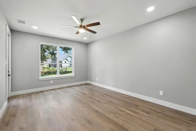 wooden floor in an empty room with a window
