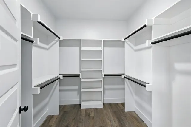 a view of walk in closet with empty racks