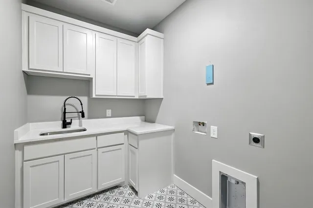 a close view of a sink and cabinets