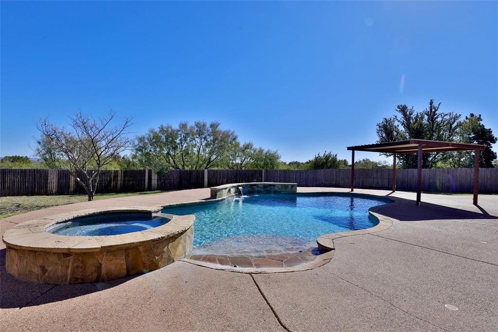 a view of a swimming pool with a lounge chair