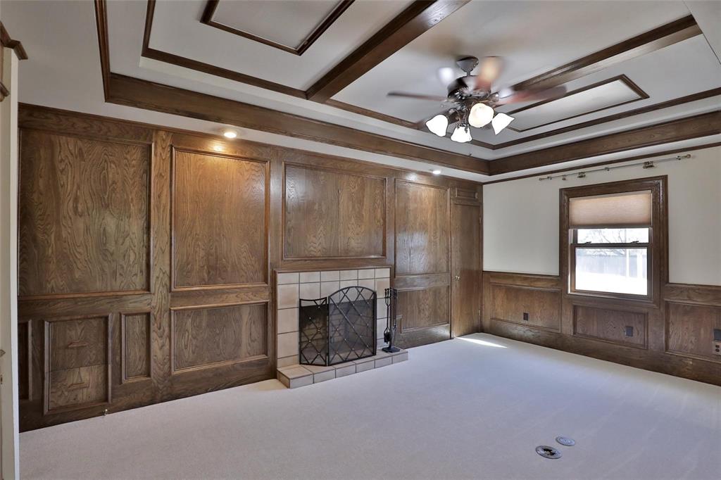 5717 Fm 2647 Winters, TX 79567 - Photo 12 of 37 an empty room with fireplace chandelier and windows