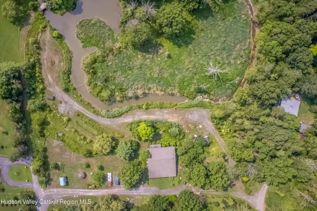 an aerial view of a residential houses with outdoor space