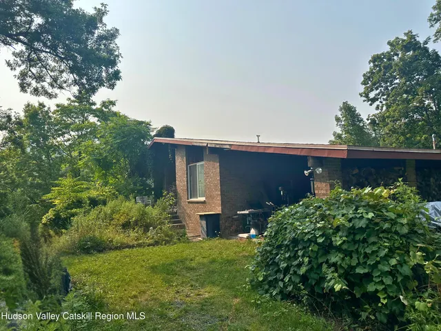 front view of a house with a tree