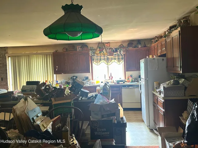 a kitchen with stainless steel appliances granite countertop a refrigerator and a stove
