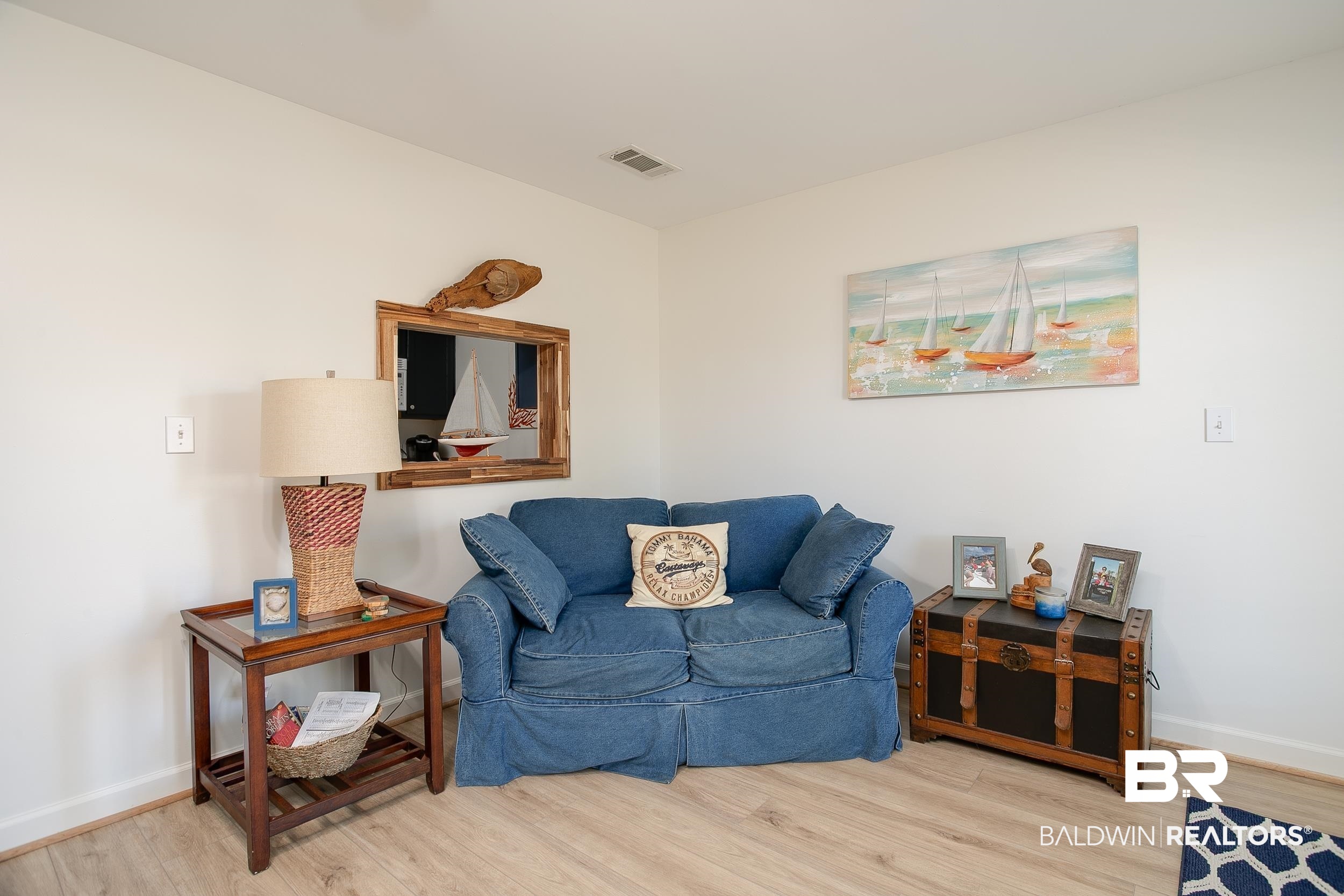 1517 Regency Road, Unit 33 Gulf Shores, AL 36542 - Photo 11 of 29 Sitting room with wood finished floors, visible vents, and baseboards