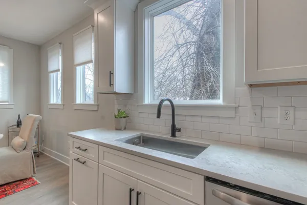 a kitchen with a sink cabinets and window