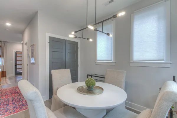 a dining room with furniture and a chandelier