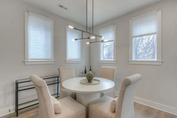 a dining room with furniture and window