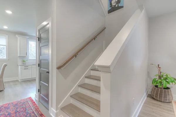 a view of entryway and hall with wooden floor