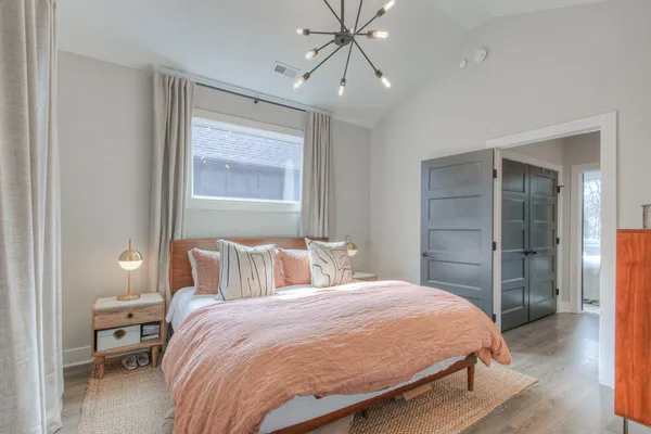 a bedroom with a bed and a window